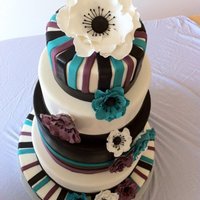 Black, Turquiose And Purple Wedding Cake This is my favorite wedding cake to date. I love the way the flowers turned out, it was my first time making gumpaste flowers, so i chose...