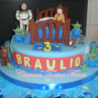 Toy Story Cake All characteres made of gum paste. Bed is a orange with chocochips cake and I used pastillaje.