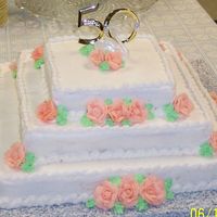 50Th Anniversary Cake 3 tier white cake, bc icing. Peach colored roses. "50" cake topper pick, swan from original cake topper (from 1957), shell...