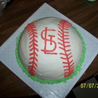 Grooms Cake For Fan Of St. Louis Cardinals cake is white, made from the Wilton sports ball pan, into a baseball, with the STL Cardinals logo piped on, and grass around the border of...