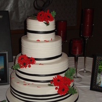 Red; Black And White Wedding Cake Bride loves red. Fondant bands with sugar daisies.
