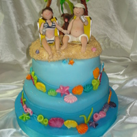 Funny Wedding Cake! This cake was made with the couple on the beach, your pet and chairs that they use when traveling. It was fun the marine theme. The shells...