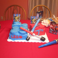 Lego Star Wars This was rough and you can totally tell my inexperience in this cake. Only 2nd time with fondant on the lightsabers...rather funny. My son...