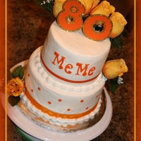 80Th Birthday Two tiers. 8 & 6 inch. All chocolate with buttercream icing and artificial flowers and ribbon. fondant name.