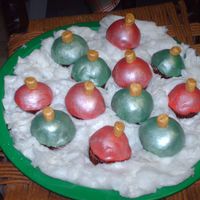 Ornament Mini Cupcakes. I made cake balls, roughly the size of a mini cupcake. Cut in half and put on top of mini cupcake. Covered in fondant and then I painted...