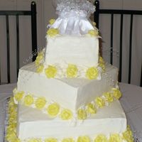 Square Wedding Cake With Yellow Roses Three teir lemon cake with lemon filling. Yellow buttercream roses.