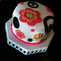 Retro Flower Birthday Cake For 13 Year Old Alternating chocolate and marble cake. Chocolate filling with buttercream icing. Fondant covered, orange, pink, green fondant flowers,...