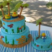 Tropical Luau Cake Buttercream wiith fruit rollups, goldfish, and cereal staws with color flow palm trees.