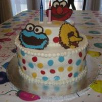 Sesame Street Buttercream with chocolate polka dots and characters.