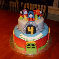 Thomas The Train Cake 12" chocolate cake with 9" vanilla cake on top decorated to look like the Round House on the bottom and a cave on top with...