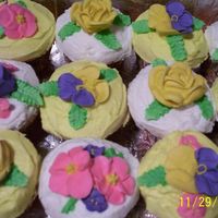 2008_165.jpg My daughter wanted cupcakes to take to school for her friends birthday. Buttercream icing w/ Royal icing flowers.
