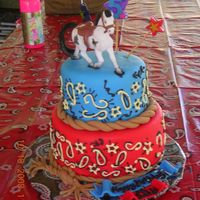 Western Style Fondant Cake For My Daughter's 5Th Birthday Party 2-tier fondant covered cake with western motif--paisley shapes, fondant rope. Added toy horse.