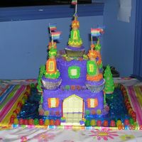Castle Cake For Daughter's 6Th Birthday 2 tier cake with buttercream icing; used sugar cones for towers and gumdrops around the edges. White chocolate for the door/drawbridge, and...