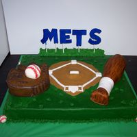 Baseball Baseball glove and ball are cake covered in buttercream. The baseball bat is also cake but it is covered in MMF and painted to give a wood-...