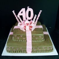 40Th Birthday Bow This is a yellow cake with double chocolate buttercream icing. The accents are made out of fondant and gumpaste.