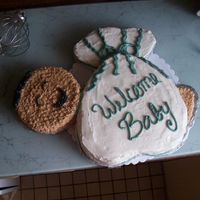 Mommys Bundle baby sitting in a storks cloth. Heart pan, 6" round and 4 mini hearts for babies feet and and the bundle at the top of the cloth.