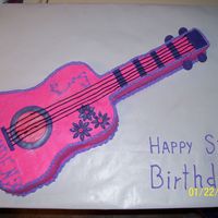 Guitar Cake Made for a little girl's rock star party. The handle is made of rice krispies. The base is a 9x13 carved. Buttercream with fondant...
