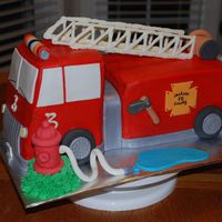 3D Firetruck This was my first firetruck cake. The cake is frosted in BC (customer's request over MMF). All detail is in MMF except the ladder...