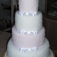 Ross And Laura's Cake Four Tier Pink and white stacked cake with sugar roses