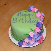 Fondant Roses Birthday Cake My second fondant cake. First attempt at fondant roses. First time trying to write with icing...cheap store bought icing that I will NEVER...