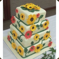 Sunflower And Gerber Daisy Wedding Cake My husband and I made this wedding cake for a bride who loved sunflowers. The cake is two flavors. It has alternating layers of WASC with...