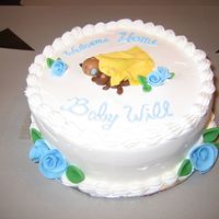 Welcome Home Baby Cake Simple 'welcome home baby' cake. Whipped icing, fondant baby, bear, blanket. Ribbon roses and leaves. Writing needs a little work...