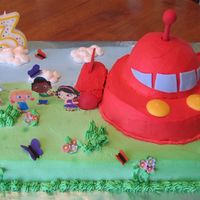 Little Einsteins Birthday Cake 9x13 sheetcake, half ball pan for rocket, and twinkies for the rocket boosters. Whipped icing - so the colors bled together badly. I...