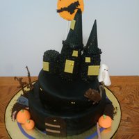 Spooky Creepy Haunted Halloween House airbrushed black. covered in fondant, all decroations except for the moon and the creepy bare trees and the castle are made of fondant. the...
