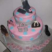 Fashionista Birthday vanilla cake with a layer of raspberry and vanilla buttercream covered in fondant all purses were made of fondant and details in food...