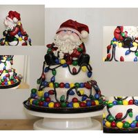 Santa Wrapped In Lights this cake is white velvet with buttercream frosting and fondant - Santa is sculpted from cake and then covered in fondant - the entire cake...