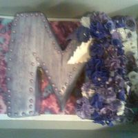 "m" Cake THIS IS A YELLOW CAKE WITH BC FROSTING, MMF, GUMPASTE CARNATIONS, ROSES, CALI LILLY, MY FIRST TIME ALOT OF THE DIFFERENT FLOWERS PAINTED...