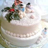 Winter Wonderland BOTTOM LAYERS OF CAKE IS VANILLA CAKE WITH PINEAPPLE FILLING, THE TOP LAYERS ARE VANILLA CAKE WITH BUTTERCREAM FROSTING, MMF COVERS CAKE...