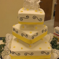 3 Tier Yellow & Black Wedd. Cake 3 tier square wedding cake with ribbon around each bottom tier and scrolls on it.