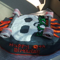 Skateboard Cake 2 - 1/4 sheet cakes trimmed in skateboard shape.all buttercream icing except for fruit by foot for wheels and the long round wafer cookies...