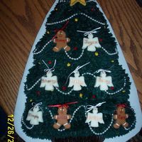 Christmas Family Tree A friend wanted this cake for her grandparent's Christmas Anniversary. The angels (girl children), gingerbread boys (boy children),...