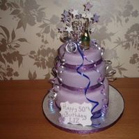 Purple 50Th Birthday Cake Purple icing, with sparkle spray and champagne bottle with glasses for a ladies 50th birthday