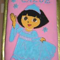 Dora Snow Princess Cake The cake is covered in pink MMF. Dora image is traced in royal icing.