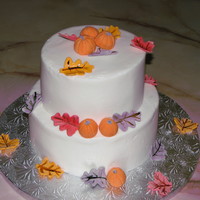 Fall Wedding Cake This was a sample cake I made for a taste testing. It was a two tiered apple cake with caramel BC with fondant leaves and pumpkins.