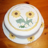 Mothers Day Cake Sponge cake filled with mascapone and blueberry, covered in buttercream and fondant. I made a plaque with sunflowers (fondant) and daisies...