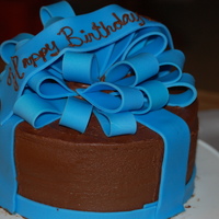 Blue And Brown Gift Chocolate icing with blue fondant bow. First attempt to make a bow like this. My mother loved it.
