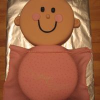 Baby Girl Cake covered in fondant. Blanket in fondant and detail on blanket in buttercream