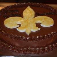 Saints Chocolate icing with fondant fleur de lis. I used the powder dust to accent.