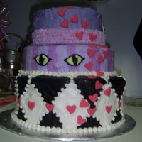 Alice In Wonderland Alice in wonderland cake with the hat as the top layer, cheshire cat as the bottom and red queen checkerboard for the bottom.