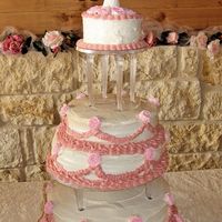 My First Wedding Cake This was my first ever wedding cake. It was for my dad and new step-mom's wedding. It started to lean because it was in May in South...