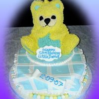 Christening Cake Wilton teddy bear iced in buttercream on round cake iced in fondant.