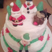 Christmas Winter Fun! Santa, Rudolph, Elf, and Frosty fondant 3D characters on top of a two tier dulce de leche cake.