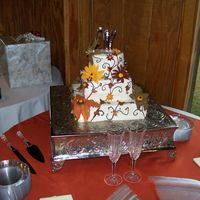 100_0016.jpg This is the second wedding cake with gumpaste flowers, but the third actual wedding cake! This cake has buttercream icing, bottom and top...