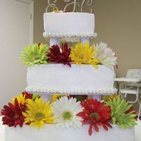 Gerber Daisy Wedding Cake This is my first attempt at a wedding cake for anyone other than a family member. It is a three tiered, sqare cake with buttercream icing...