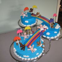 Diaper Downpour The cake is covered in buttercream and the babies / rainbows are made of fondant.