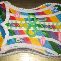 Pride Corsett Cake this is a gay pride corsett cake, the sides are a ribbon, the boobs are cupcakes, I love the cake but not the boobs, they are bad.